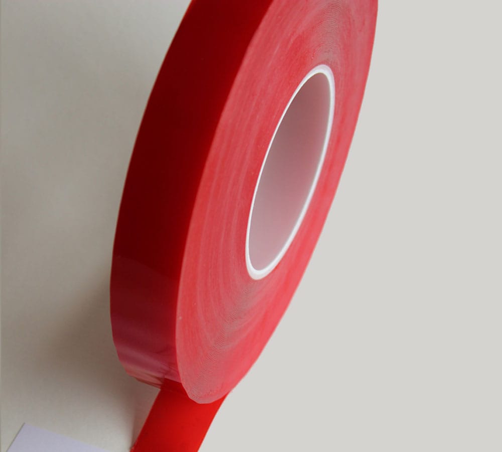 Red acrylic tape roll for industrial use with a white core.